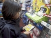 In this photo provided by Nintendo of America, Joanna Reyes, 10, of Seattle searches the shelves at the GameStop Southcenter store in Seattle in pursuit of New Super Mario Bros. 2, a must-have Nintendo 3DS game, during a Black Friday shopping trip on Nov. 23, 2012.