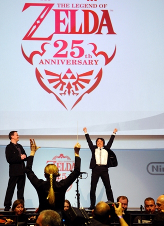 In this photo provided by Nintendo of America, Nintendo game designer Shigeru Miyamoto (R) helps conduct an orchestra performance commemorating the 25th anniversary of 'The Legend of Zelda' franchise, during opening day of the 2011 Electronic Entertainment Expo (E3), June 7, 2011 in Los Angeles. The E3 is the video game industry's premier trade show. (Photo by Nintendo of America, Bob Riha, Jr.) No Sales